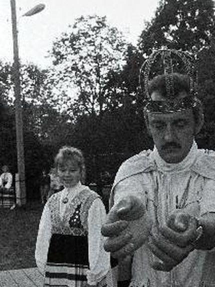 Kirill I ja Valdek Kaus tegelemas rahapesuga - Torgu Kuningriigi vastvalminud õliste müntide avalik viinaga pesemine Sörulaste ülemaailmsel kokkutulekul, 1993 aasta jaanipäeval, Iidel, Torgu vallamaja õue peal. Tagapool seismas vallasekretär Ülle Nakurt.